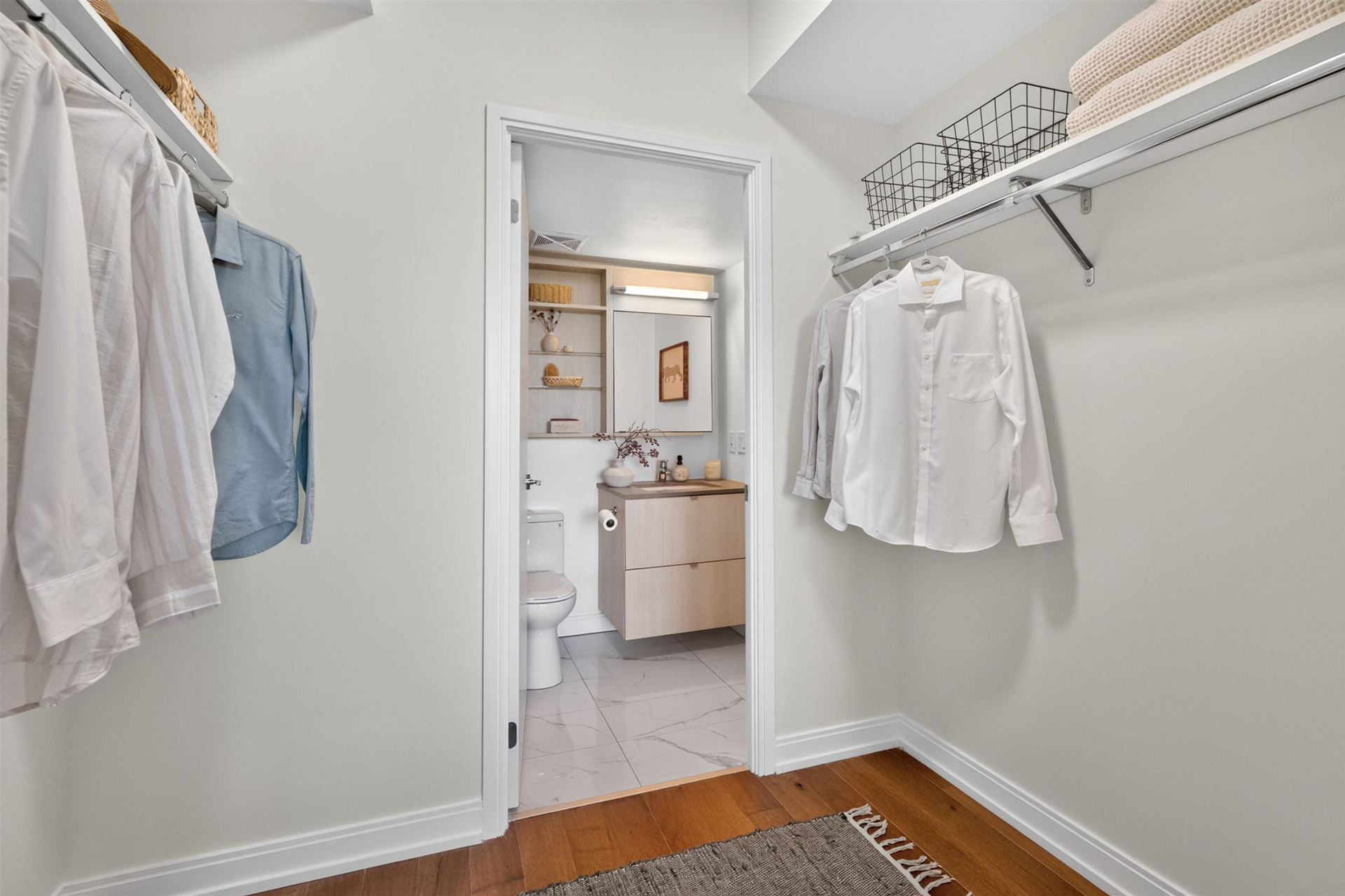 Walk-through closet leading to the ensuite bathroom