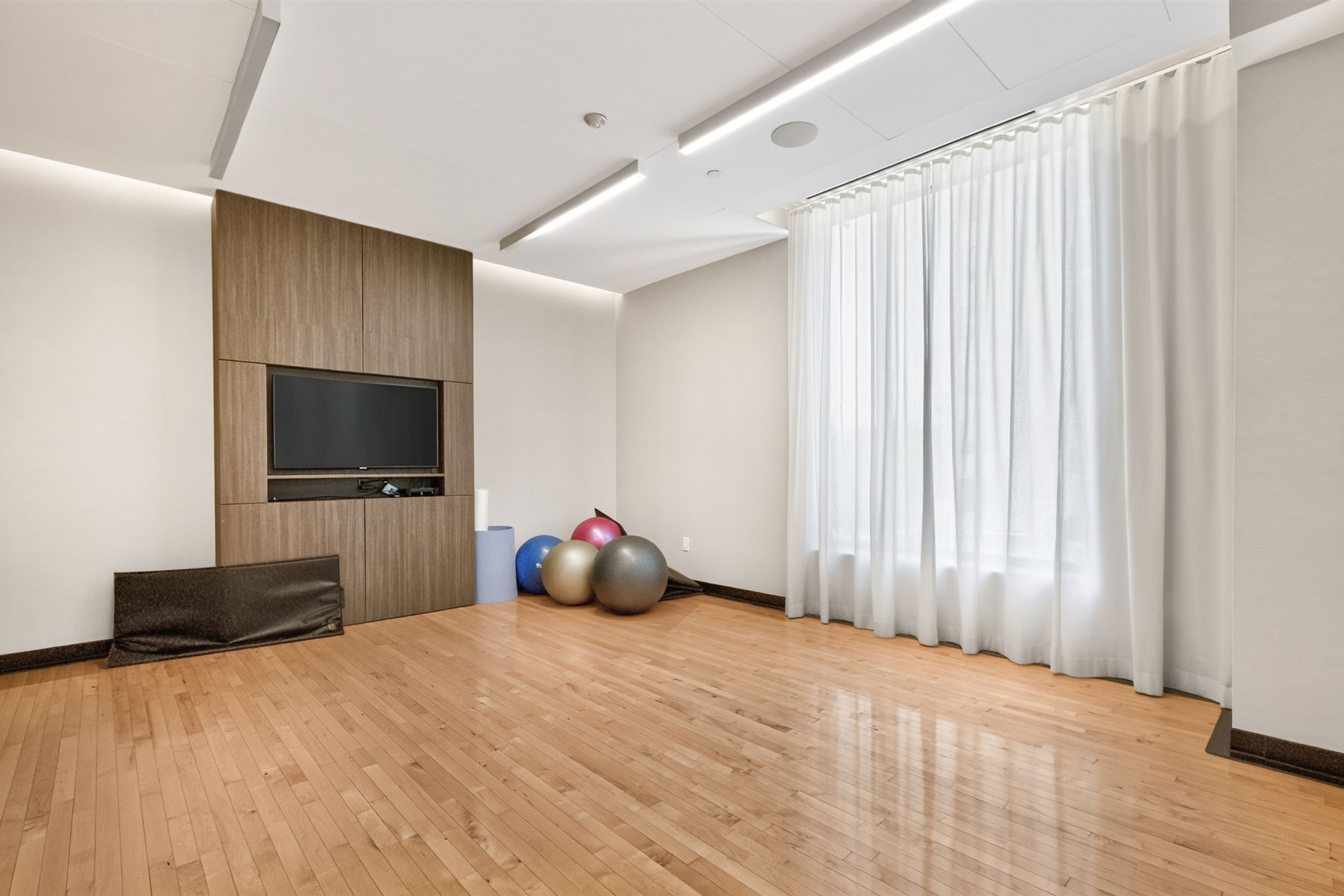 Yoga and stretch studio with hardwood floors