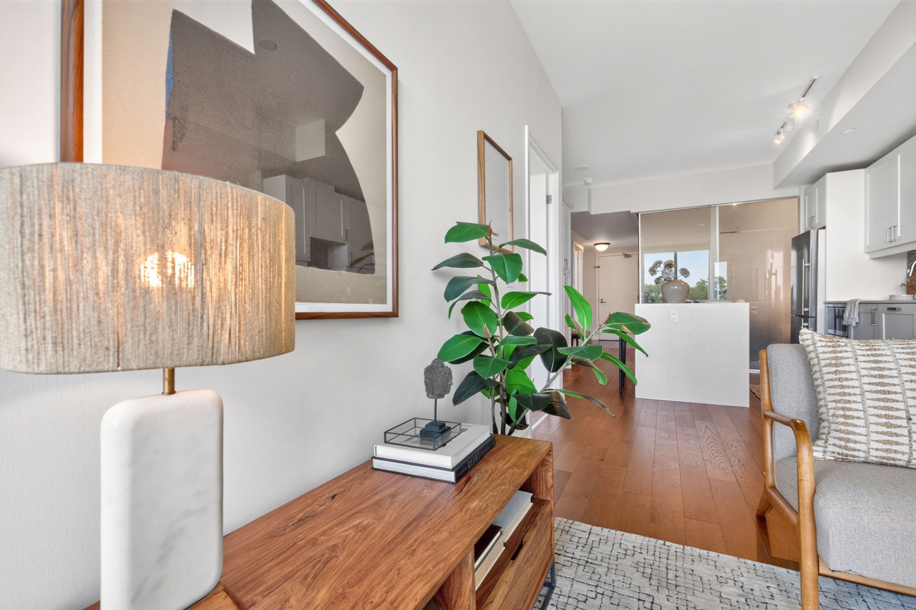 Living room detail with console table and view toward the kitchen
