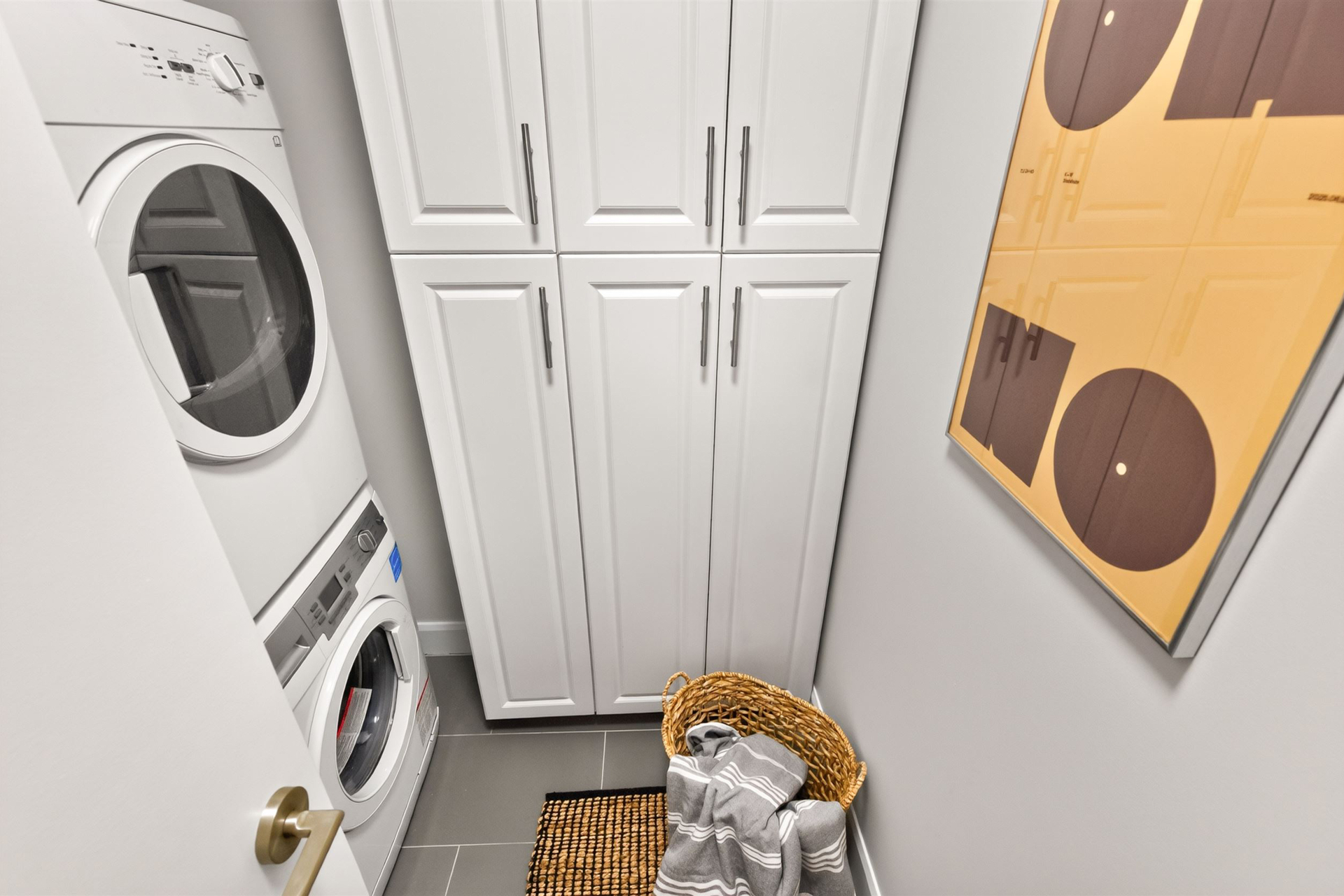 Separate laundry room with Blomberg stacked washer and dryer